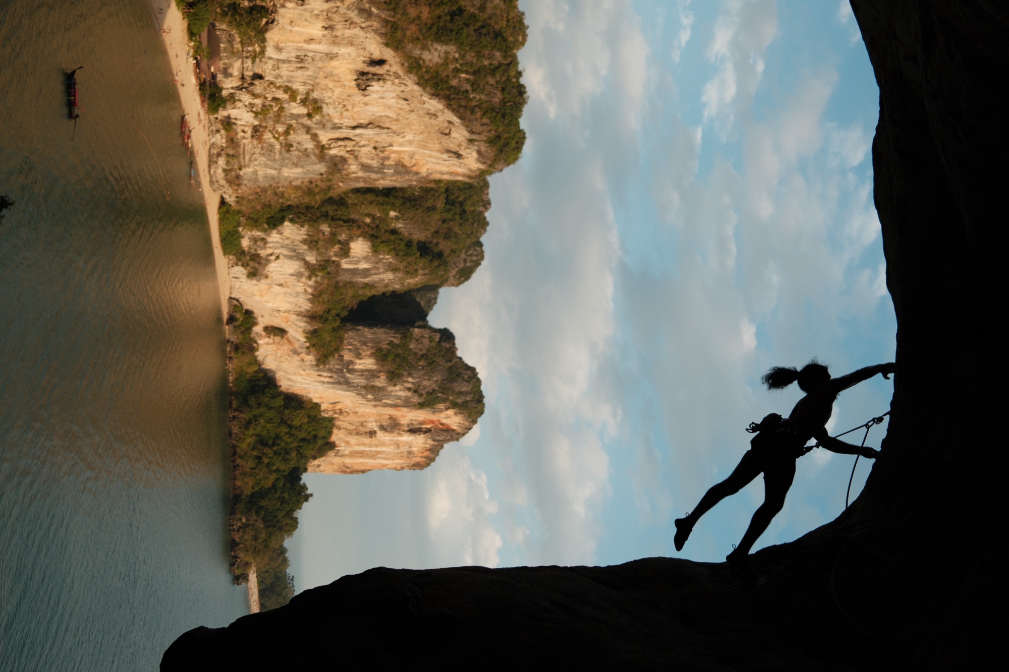 A climber on a limestone sea cliff