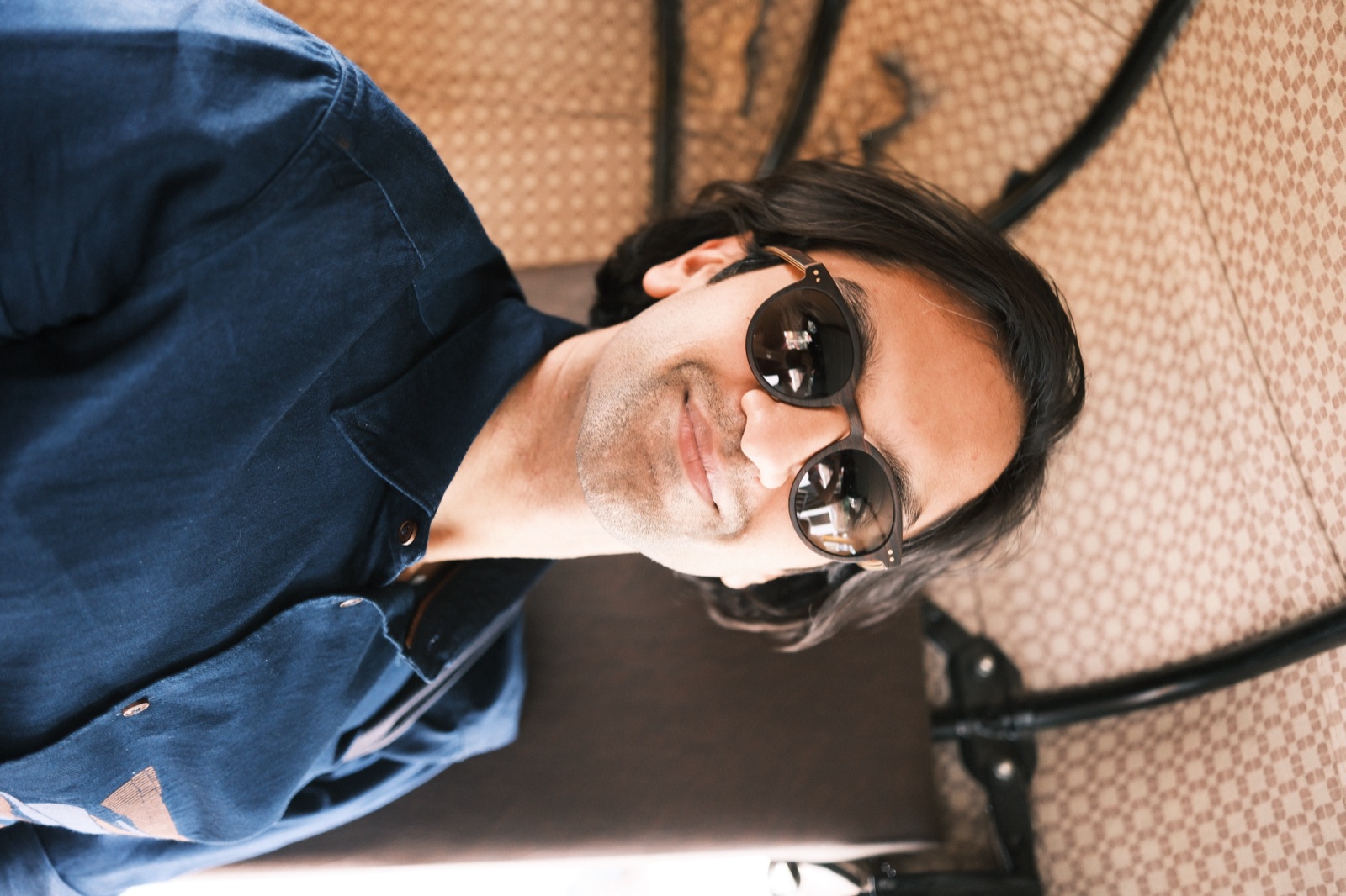 Yaduraj Bhageria, smiling, in sunglasses and a navy shirt