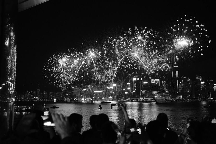 Fireworks over a harbour at night